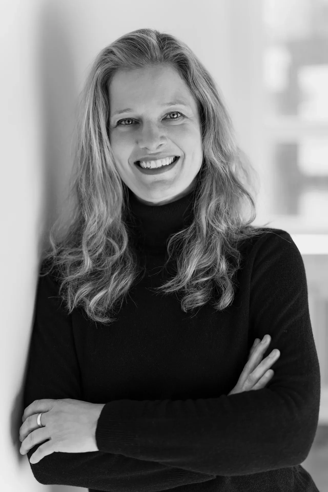 Personal Branding Fotografie Hamburg: lächelnde Unternehmerin im dunklen Rollkragenpullover – Schwarzweiß-Portrait für Website und LinkedIn